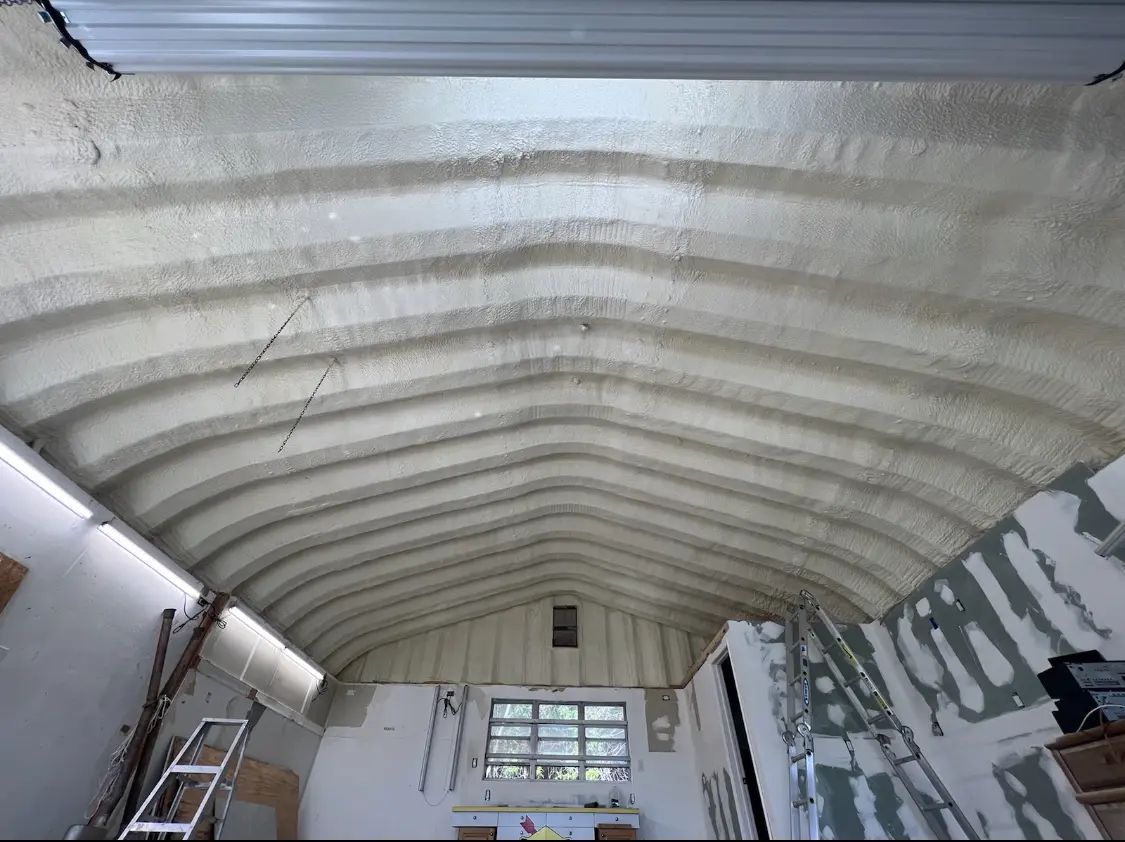 Spray polyurethane foam applied to the underside of a metal roof deck in Wall